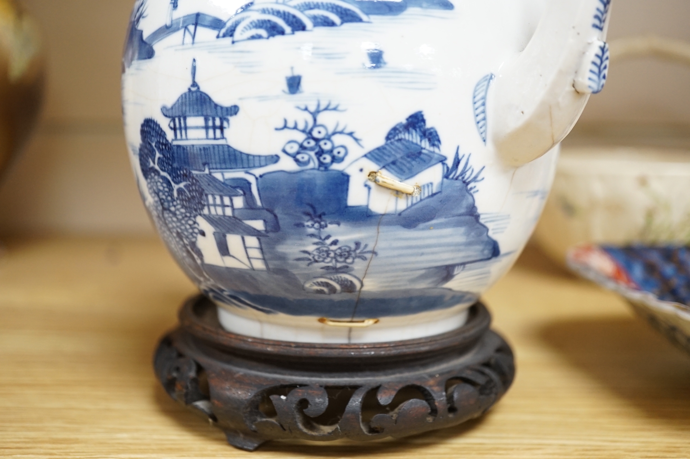 An 18th century Chinese blue and white teapot and cover, with hardwood stand, 19cm total height